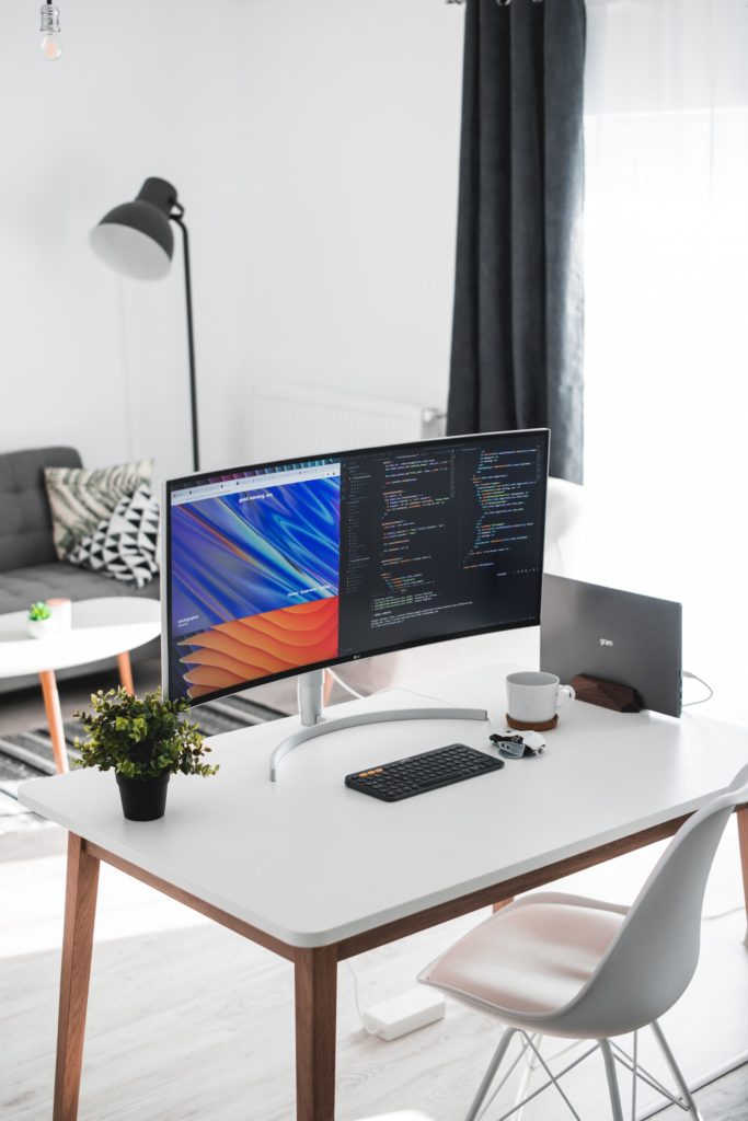 Curved PC monitor on white desk